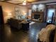 Comfortable living room featuring a stone fireplace, hardwood floors, and inviting seating arrangements at 512 S Holly Springs Rd, Woodstock, GA 30188