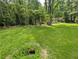 Expansive yard with mature trees, lush greenery, and natural landscaping at 512 S Holly Springs Rd, Woodstock, GA 30188