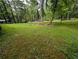 Expansive yard with mature trees and lush greenery surrounding the property at 512 S Holly Springs Rd, Woodstock, GA 30188