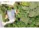Birds eye view of a house with a gray roof surrounded by many trees at 1558 Amberwood Creek Nw Dr, Kennesaw, GA 30152