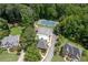 Aerial view of community pool and tennis courts surrounded by lush greenery and homes at 1558 Amberwood Creek Nw Dr, Kennesaw, GA 30152