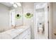 Bathroom with granite countertop, white cabinets, and a decorative flower wall hanging at 1558 Amberwood Creek Nw Dr, Kennesaw, GA 30152