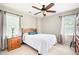 Bright bedroom with neutral walls, a ceiling fan, and two large windows at 1558 Amberwood Creek Nw Dr, Kennesaw, GA 30152