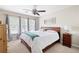 Comfortable bedroom with large windows, ceiling fan, and neutral tones at 1558 Amberwood Creek Nw Dr, Kennesaw, GA 30152