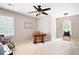Comfortable bedroom with neutral carpet, a ceiling fan, and a cozy rocking chair at 1558 Amberwood Creek Nw Dr, Kennesaw, GA 30152