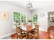 Bright dining area with wood floors, natural light, and views of the landscaped yard at 1558 Amberwood Creek Nw Dr, Kennesaw, GA 30152