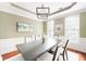 Elegant dining room featuring wood flooring, wainscoting and tray ceiling at 1558 Amberwood Creek Nw Dr, Kennesaw, GA 30152