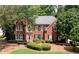 Beautiful brick home with manicured lawn and landscaping at 1558 Amberwood Creek Nw Dr, Kennesaw, GA 30152