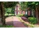 A brick path leads to a classic home, framed by greenery and manicured shrubbery at 1558 Amberwood Creek Nw Dr, Kennesaw, GA 30152
