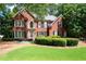 Charming brick home featuring manicured landscaping and a welcoming front lawn at 1558 Amberwood Creek Nw Dr, Kennesaw, GA 30152