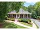Charming cottage-style home with a lovely front porch and manicured lawn at 1558 Amberwood Creek Nw Dr, Kennesaw, GA 30152