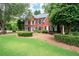 Charming brick home with black shutters and manicured landscaping in the front yard at 1558 Amberwood Creek Nw Dr, Kennesaw, GA 30152