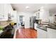 Well-lit kitchen featuring stainless steel appliances, granite countertops, and hardwood floors at 1558 Amberwood Creek Nw Dr, Kennesaw, GA 30152