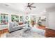 Open-concept living room with hardwood floors and an adjoining kitchen and dining area at 1558 Amberwood Creek Nw Dr, Kennesaw, GA 30152