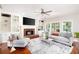Spacious living room with a fireplace, built-in shelving, and large windows at 1558 Amberwood Creek Nw Dr, Kennesaw, GA 30152