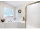 Well-lit main bathroom featuring a soaking tub with jets and a glass enclosed shower at 1558 Amberwood Creek Nw Dr, Kennesaw, GA 30152