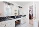 Spacious bathroom with dual sink vanity, marble counters and decorative light fixtures at 1558 Amberwood Creek Nw Dr, Kennesaw, GA 30152