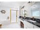 Bright main bathroom with double sink vanity, granite counters, tub and glass enclosed shower at 1558 Amberwood Creek Nw Dr, Kennesaw, GA 30152