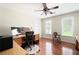Bright office space with a ceiling fan, desk, and two windows offering natural light at 1558 Amberwood Creek Nw Dr, Kennesaw, GA 30152