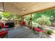 Relaxing covered patio with outdoor furniture and a peaceful backyard setting at 1558 Amberwood Creek Nw Dr, Kennesaw, GA 30152