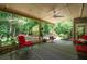 Cozy covered patio with comfortable seating and a serene view of the surrounding woods at 1558 Amberwood Creek Nw Dr, Kennesaw, GA 30152