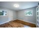 Bedroom with hardwood floors, two windows, and white-framed sliding door at 3042 Monterey Dr, Decatur, GA 30032