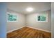 Small bedroom with hardwood floors and two windows at 3042 Monterey Dr, Decatur, GA 30032