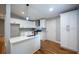 Modern kitchen with white cabinets, quartz countertops, stainless steel appliances, and stylish fixtures at 3042 Monterey Dr, Decatur, GA 30032