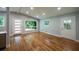 Bright, airy living room boasts hardwood floors, updated lighting and doors that let the sun shine in at 3042 Monterey Dr, Decatur, GA 30032