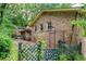 View of the brick house back exterior featuring a charming arbor and lush landscape at 3206 Pyrite Sw Cir, Atlanta, GA 30331