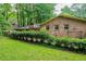 Brick house back exterior featuring an arbor and green landscape, offering an ideal outdoor space at 3206 Pyrite Sw Cir, Atlanta, GA 30331
