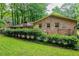 Brick house back exterior featuring an arbor and green landscape, enhancing the property's appeal at 3206 Pyrite Sw Cir, Atlanta, GA 30331