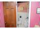Quaint powder room with red and white striped wallpaper and classic fixtures at 3206 Pyrite Sw Cir, Atlanta, GA 30331
