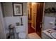 Retro bathroom featuring white tile, classic fixtures, and patterned wallpaper at 3206 Pyrite Sw Cir, Atlanta, GA 30331