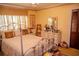 Comfortable bedroom with yellow walls, a metal bed frame, and plenty of natural light at 3206 Pyrite Sw Cir, Atlanta, GA 30331