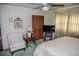 This bedroom has vintage wallpaper, a ceiling fan, and ample natural light at 3206 Pyrite Sw Cir, Atlanta, GA 30331