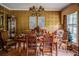 Elegant dining room with a formal wooden table set for a meal, chandelier, and decorative accents at 3206 Pyrite Sw Cir, Atlanta, GA 30331