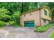 Side view of brick home with green trim and large driveway at 3206 Pyrite Sw Cir, Atlanta, GA 30331