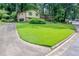 Residential house with large front lawn and a paved driveway with parking area at 3206 Pyrite Sw Cir, Atlanta, GA 30331