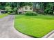 Two-story home with large front lawn, brick and siding facade and mature tree coverage at 3206 Pyrite Sw Cir, Atlanta, GA 30331