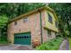 Home featuring a brick exterior, green trim, and lush greenery at 3206 Pyrite Sw Cir, Atlanta, GA 30331
