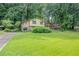 Two-story home featuring a large front lawn and mature trees around the property at 3206 Pyrite Sw Cir, Atlanta, GA 30331