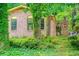 Brick and siding home with an arched brick wall amid mature trees and lush landscaping at 3206 Pyrite Sw Cir, Atlanta, GA 30331