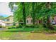 Residential home partially obscured by lush trees with brick and siding design at 3206 Pyrite Sw Cir, Atlanta, GA 30331