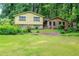 Two-story house with a well-maintained lawn and greenery in front at 3206 Pyrite Sw Cir, Atlanta, GA 30331