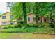 Residential home partially obscured by lush trees and greenery in a natural setting at 3206 Pyrite Sw Cir, Atlanta, GA 30331