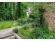 Brick home surrounded by mature trees and greenery, offering a secluded and private setting at 3206 Pyrite Sw Cir, Atlanta, GA 30331
