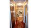 Hallway with hardwood floors, patterned wallpaper and decorative lighting at 3206 Pyrite Sw Cir, Atlanta, GA 30331