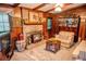 Spacious wood-paneled living room features a brick fireplace, classic decor, and comfortable seating for a cozy retreat at 3206 Pyrite Sw Cir, Atlanta, GA 30331