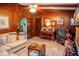 Warm, wood-paneled living room with a comfortable sofa, piano, and entertainment center, creating a cozy atmosphere at 3206 Pyrite Sw Cir, Atlanta, GA 30331